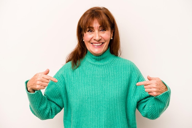 Middle age caucasian woman isolated on white background surprised pointing with finger smiling broadly