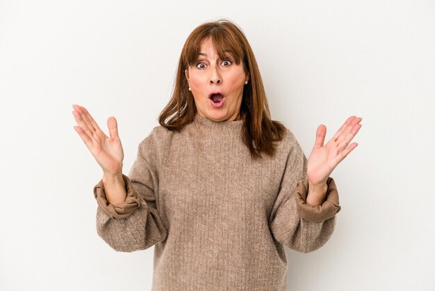 Middle age caucasian woman isolated on white background surprised and shocked.