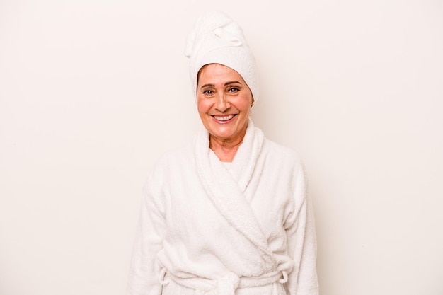 Middle age caucasian woman wearing a bathrobe isolated on white background happy smiling and cheerful