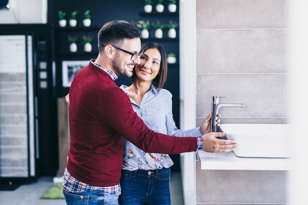 Middle age couple choosing new ceramic tiles and utensils for their bathroom