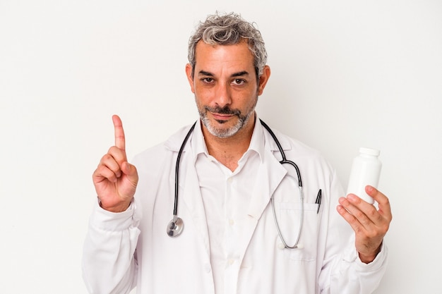 Middle age doctor caucasian man isolated on white background  showing number one with finger.