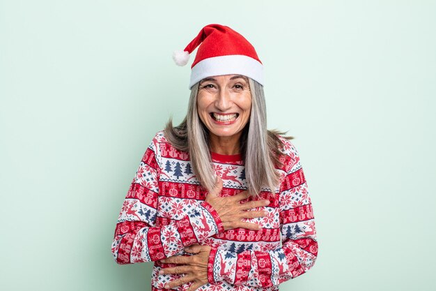 Middle age gray hair woman laughing out loud at some hilarious joke. christmas concept