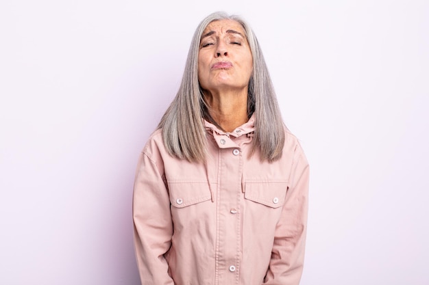 Middle age gray hair woman pressing lips together with a cute, fun, happy, lovely expression, sending a kiss