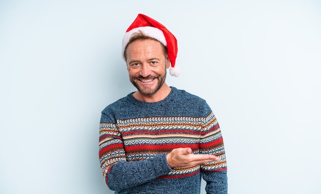 Middle age handsome man smiling cheerfully, feeling happy and showing a concept. christmas concept
