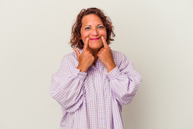 Middle age latin woman isolated on white background doubting between two options.