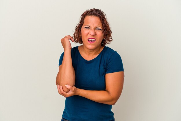 Middle age latin woman isolated on white background massaging elbow, suffering after a bad movement.