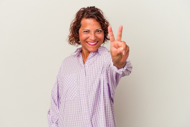 Middle age latin woman isolated on white background showing number two with fingers.