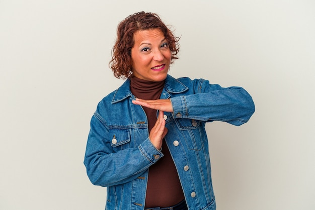 Middle age latin woman isolated on white background showing a timeout gesture.