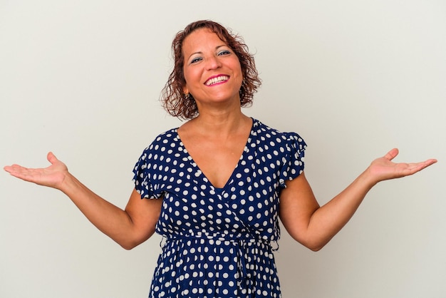 Middle age latin woman isolated on white background showing a welcome expression.