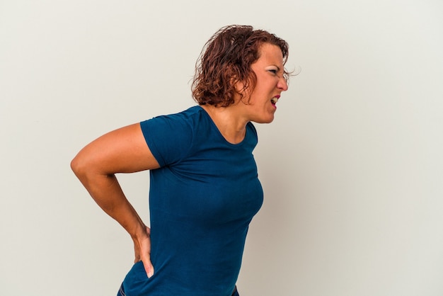 Middle age latin woman isolated on white background suffering a back pain.