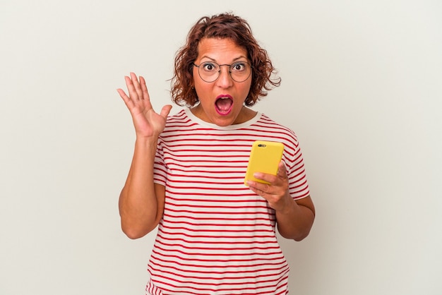 Middle age latin woman isolated on white background surprised and shocked.