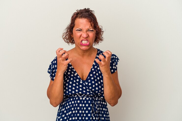 Photo middle age latin woman isolated on white background upset screaming with tense hands.