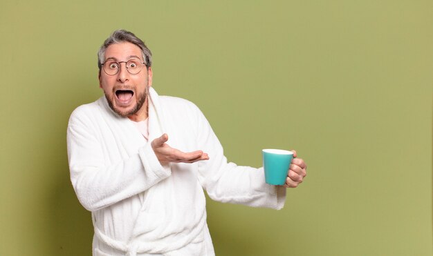 Middle age man awaking with a coffee cup