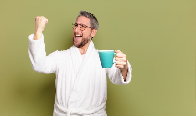 Middle age man awaking with a coffee cup