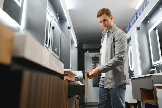 Middle age man choosing bathroom sink and utensils for his home