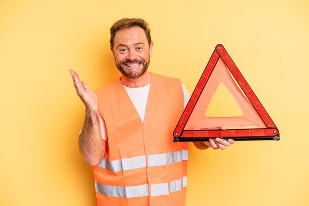 Middle age man feeling happy and astonished at something unbelievable triangle breakdown car concept