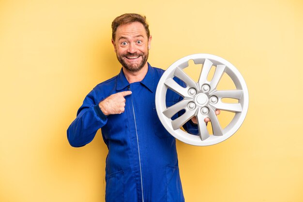 Middle age man feeling happy and pointing to self with an excited. car mechanic concept