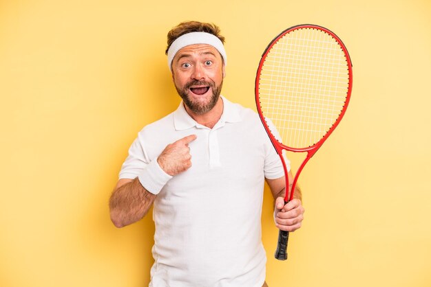 middle age man feeling happy and pointing to self with an excited tennis concept