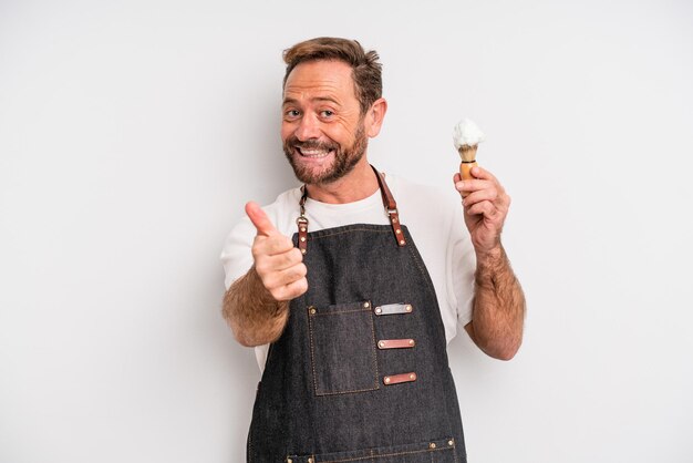 Middle age man feeling proud,smiling positively with thumbs up. barber concept