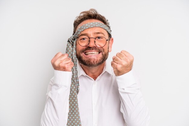 Middle age man feeling shockedlaughing and celebrating success business company party concept