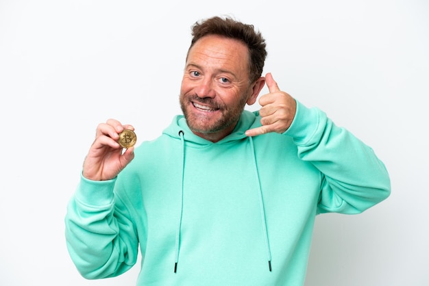 Middle age man holding a Bitcoin over isolated background making phone gesture Call me back sign