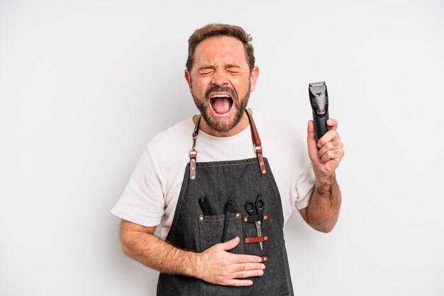 Middle age man laughing out loud at some hilarious joke. barber concept