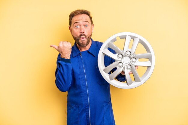 Middle age man looking astonished in disbelief. car mechanic concept