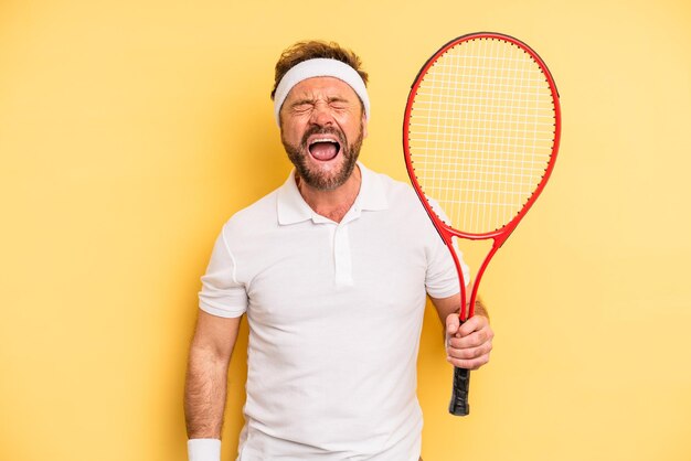 Мужчина средних лет агрессивно кричит, выглядит очень злым. концепция тенниса