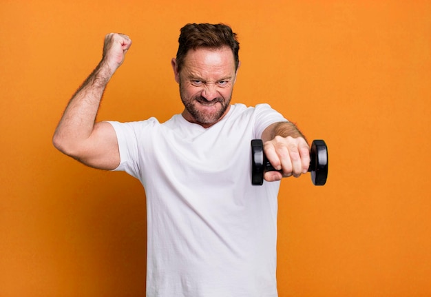 Middle age man with a dumbbell fitness concept