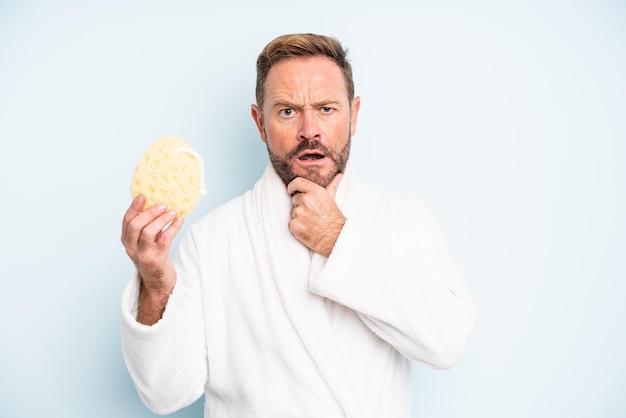 Middle age man with mouth and eyes wide open and hand on chin. shower concept