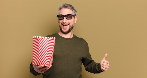 Middle age man with a popcorn bucket