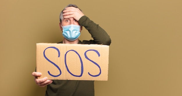 middle age man with a protective mask needing help
