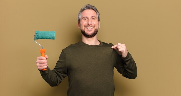 Middle age man with a roller paint decorating concept