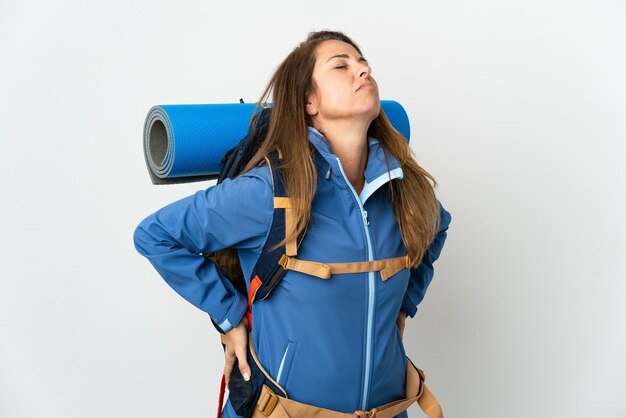 Middle age mountaineer woman with a big backpack isolated