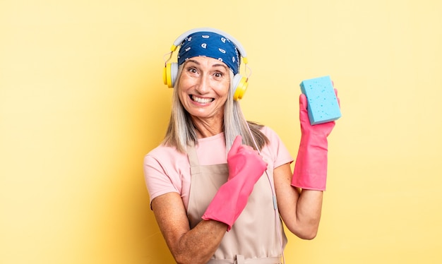 Middle age pretty woman feeling happy and facing a challenge or celebrating. scourer cleaner