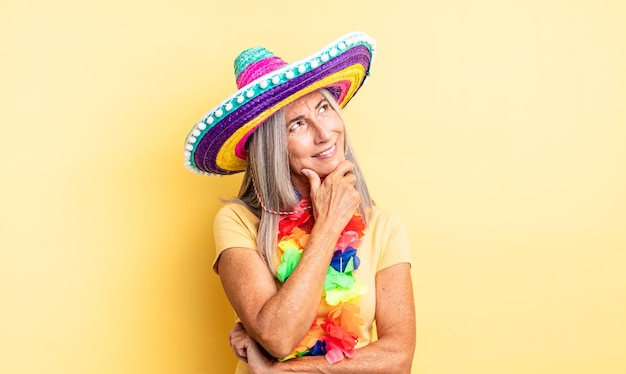 Middle age pretty woman smiling with a happy, confident expression with hand on chin. mexican party concept