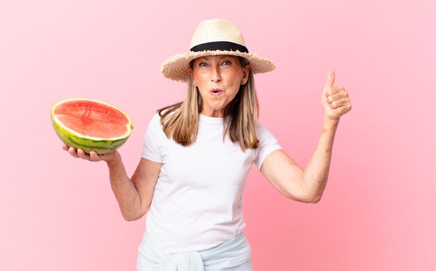 Middle age pretty woman with a watermelon. summer concept