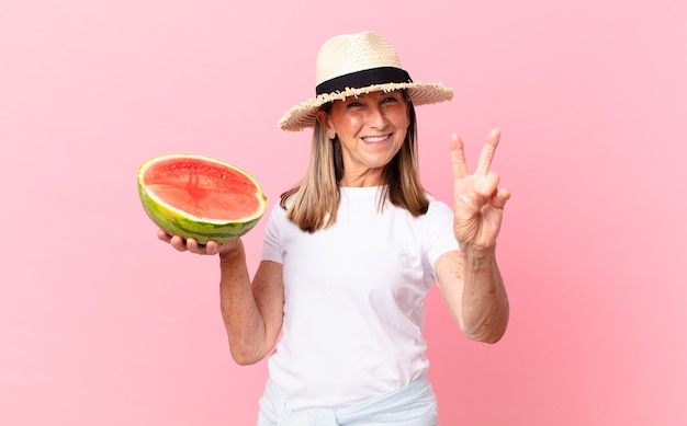 Middle age pretty woman with a watermelon. summer concept