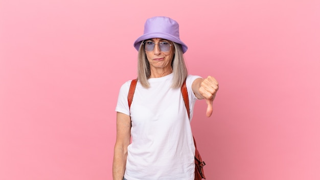 Middle age white hair woman feeling cross,showing thumbs down. summer concept