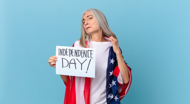 Middle age white hair woman feeling stressed, anxious, tired and frustrated. independence day concept