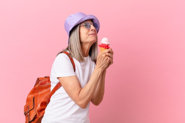 Middle age white hair woman with an ice cream. summer concept