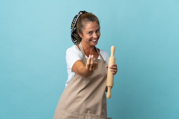 Middle age woman in chef uniform making money gesture