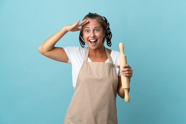 Middle age woman in chef uniform with surprise expression