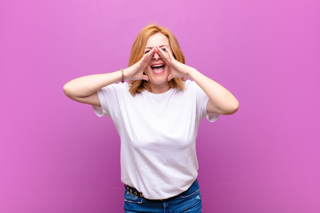 Middle age woman feeling happy, excited and positive, giving a big shout out with hands next to mouth, calling out