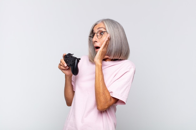 Middle age woman feeling happy, excited and surprised