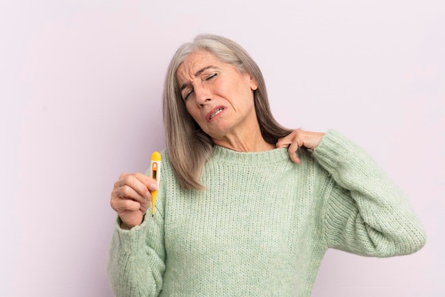 Middle age woman feeling stressed anxious tired and frustrated medicine thermometer concept