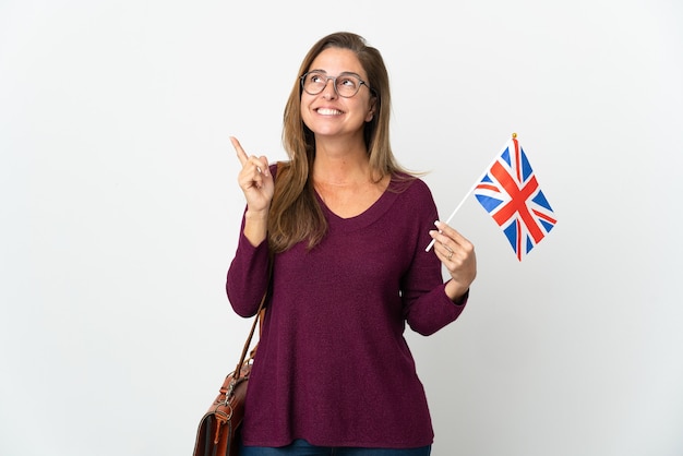 Middle age woman holding an United Kingdom flag isolated