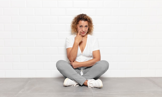 Middle age woman keeping an eye on you, not trusting, watching and staying alert and vigilant