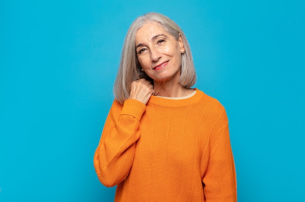 Middle age woman laughing cheerfully and confidently with a casual, happy, friendly smile