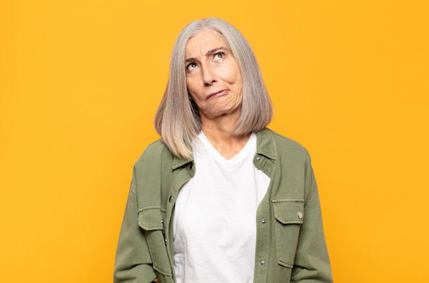 Middle age woman looking goofy and funny with a silly cross-eyed expression, joking and fooling around